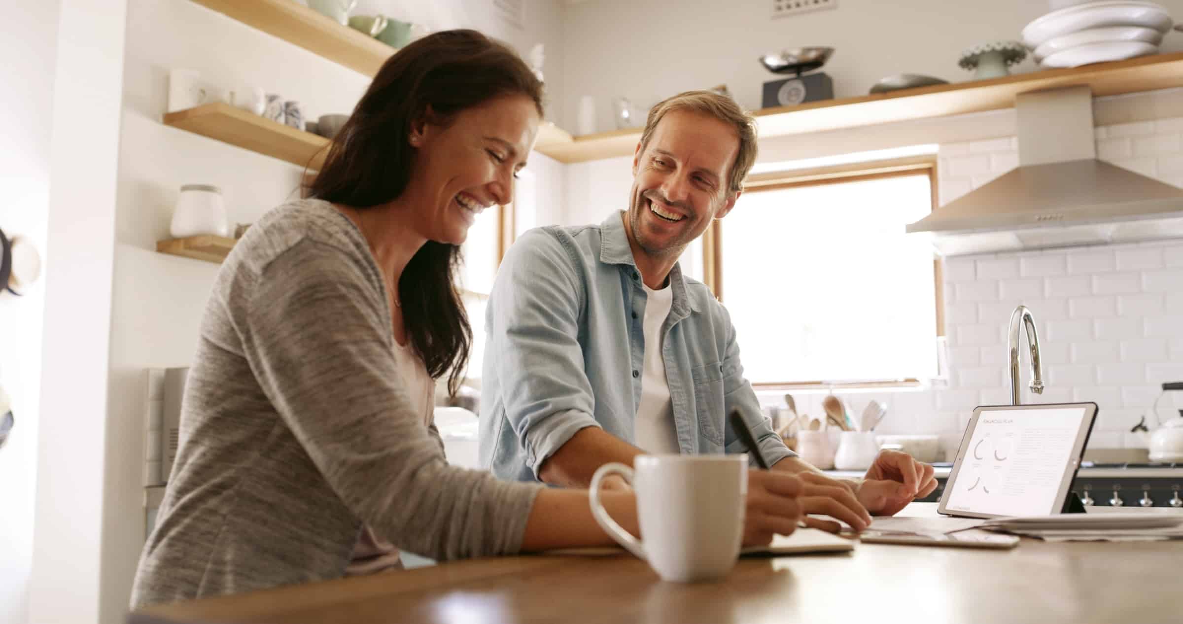 Happy couple reviewing home energy loan options together from Efficiency Maine
